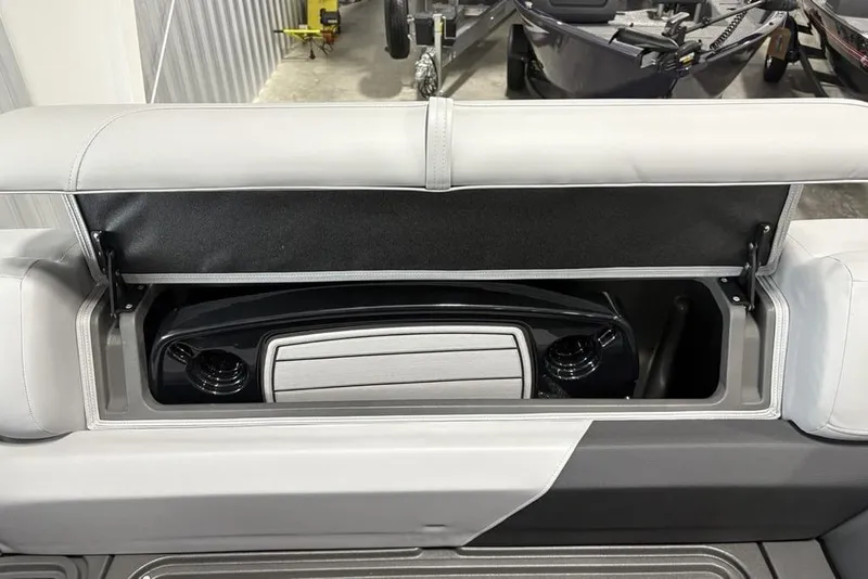 The Image of 2026 Sun Tracker SportFish 20 DLX pontoon boat in a showroom setting. - 2