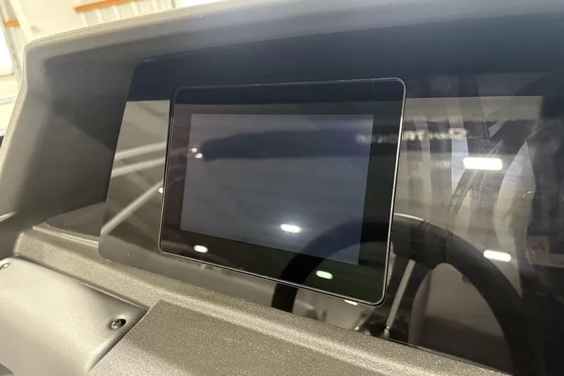 Slide: The Image of 2026 Sun Tracker SportFish 20 DLX boat console with integrated cup holders and storage. - 22