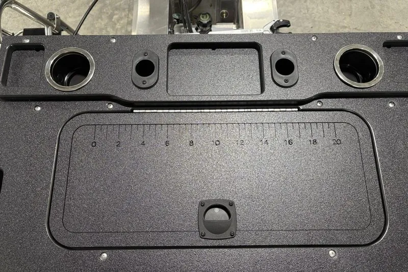 Slide: The Image of 2026 Sun Tracker SportFish 20 DLX boat dashboard with cup holders and measurement markings. - 28