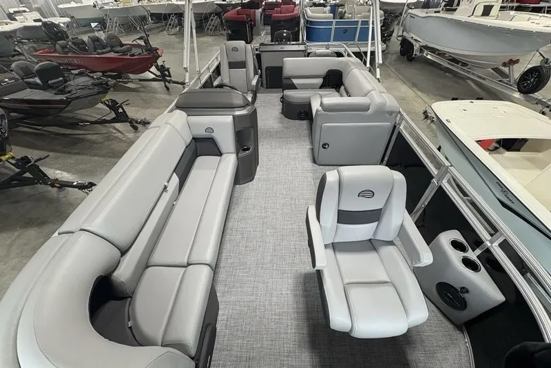 Slide: The Image of 2026 Sun Tracker SportFish 20 DLX pontoon boat with spacious seating in showroom. - 29