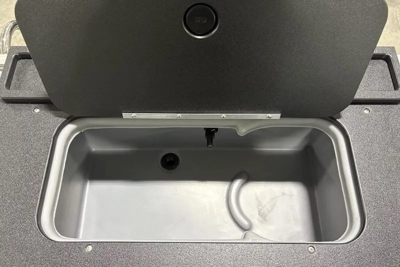 Slide: The Image of Livewell compartment in 2026 Sun Tracker SportFish 20 DLX boat, open lid view. - 30