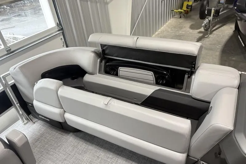 Slide: The Image of 2026 Sun Tracker SportFish 20 DLX pontoon boat with Mercury engine in a showroom. - 4