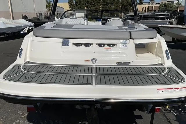 Slide: The Image of 2025 Bayliner VR6 Bowrider I/O boat, rear view with swim platform and seating. - 11
