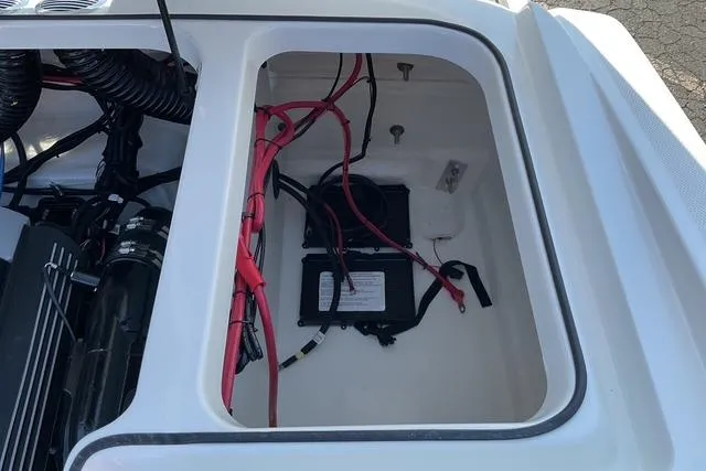 Slide: The Image of 2025 Bayliner VR6 Bowrider I/O engine compartment with visible wiring and battery. - 19