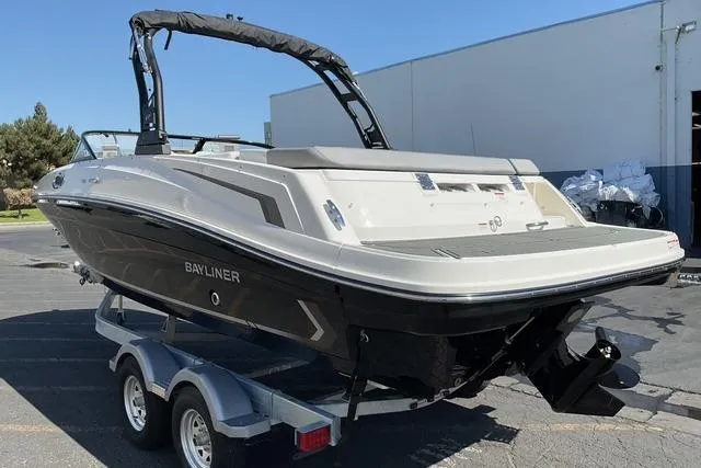 Slide: The Image of 2025 Bayliner VR6 Bowrider I/O boat on trailer, sleek design, outdoor setting. - 3