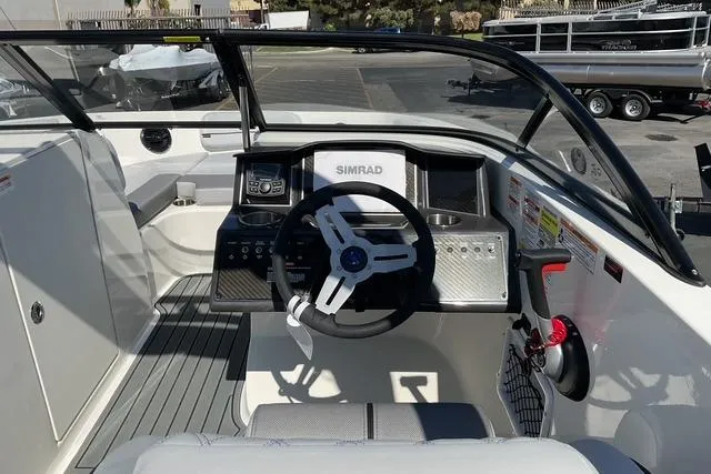 Slide: The Image of 2025 Bayliner VR6 Bowrider I/O cockpit with steering wheel and navigation system. - 8
