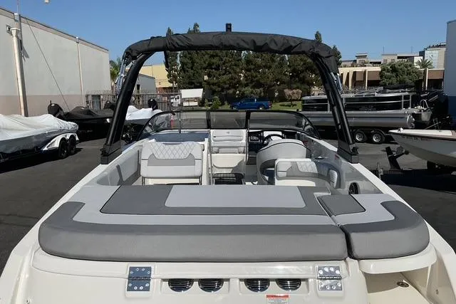 Slide: The Image of 2025 Bayliner VR6 Bowrider I/O boat, rear view, parked outdoors, showcasing seating and interior. - 9