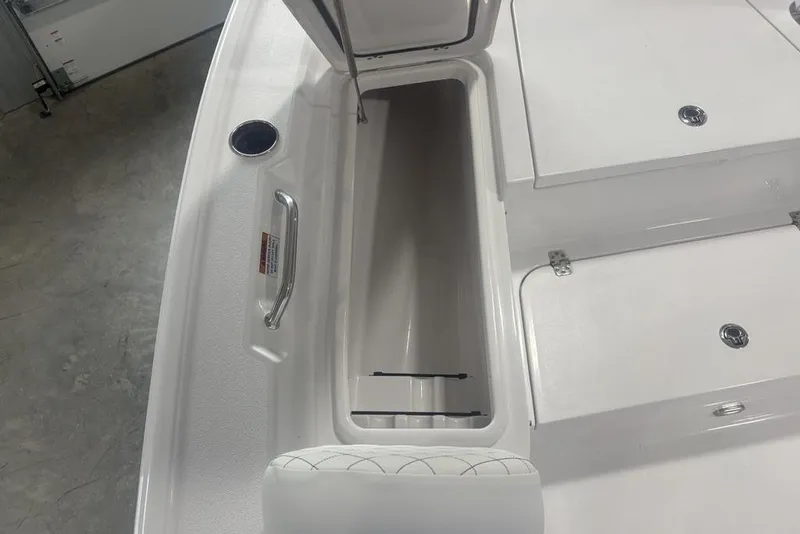 Slide: The Image of 2026 Sportsman Masters 227 boat interior storage compartment with open hatch. - 11
