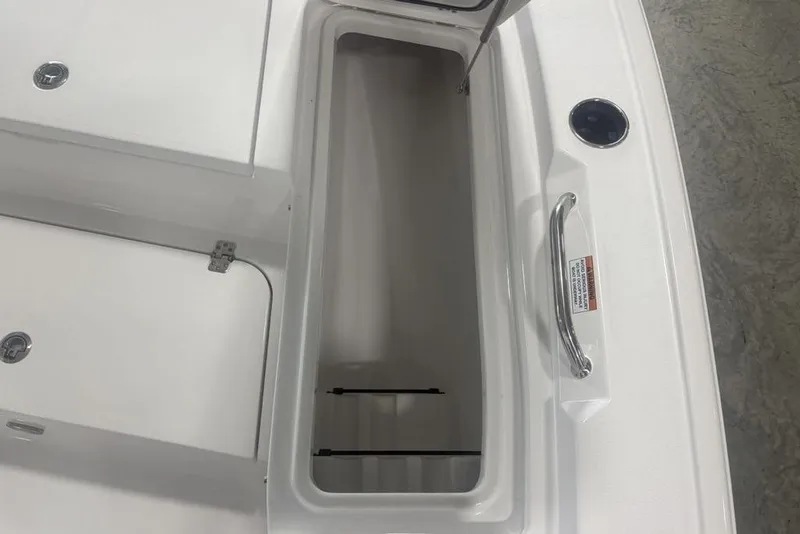 Slide: The Image of Open storage compartment on 2026 Sportsman Masters 227 boat, featuring stainless steel handle. - 12