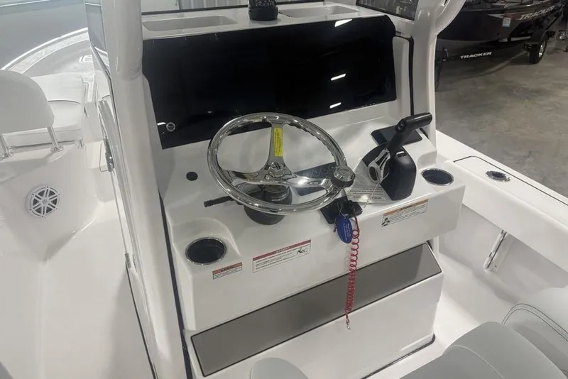 Slide: The Image of 2026 Sportsman Masters 227 boat console with steering wheel and controls. - 14