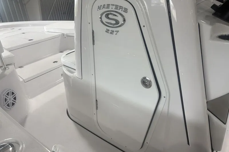 Slide: The Image of 2026 Sportsman Masters 227 boat interior with sleek white design and seating. - 18