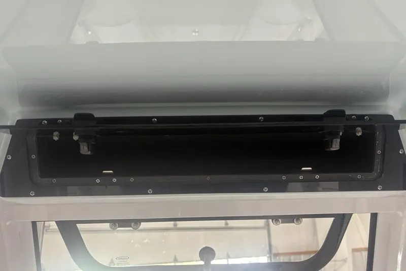 Slide: The Image of 2026 Sportsman Masters 227 boat console storage compartment, open and empty. - 24