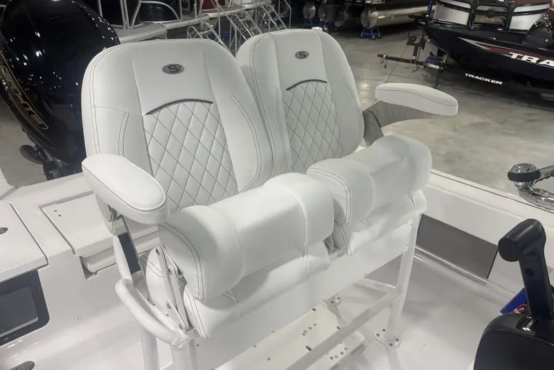 Slide: The Image of Luxury seating on 2026 Sportsman Masters 227 boat, featuring white cushioned armchairs. - 28