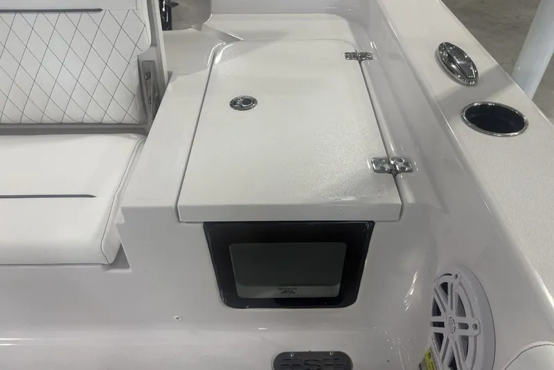 Slide: The Image of 2026 Sportsman Masters 227 boat interior with cushioned seating and storage compartment. - 31