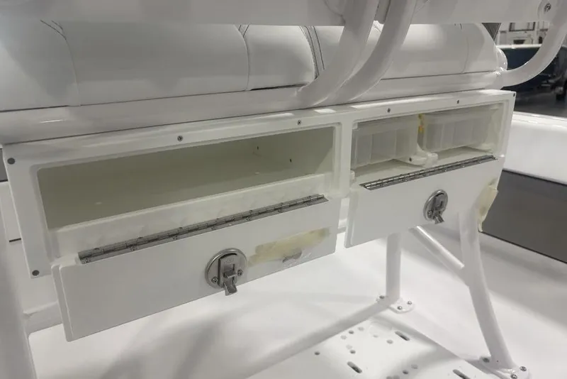 Slide: The Image of 2026 Sportsman Masters 227 boat storage compartments with secure locks and white finish. - 33