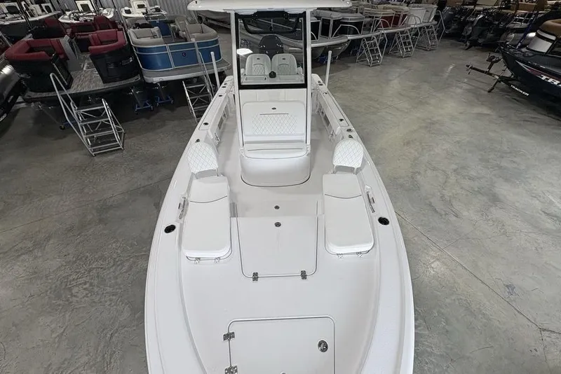 Slide: The Image of 2026 Sportsman Masters 227 boat in showroom, featuring spacious deck and seating. - 37