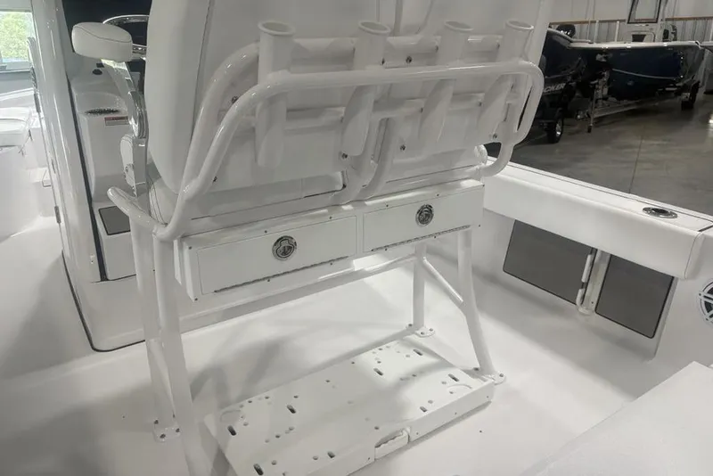 Slide: The Image of 2026 Sportsman Masters 227 boat interior with rod holders and storage drawers. - 38