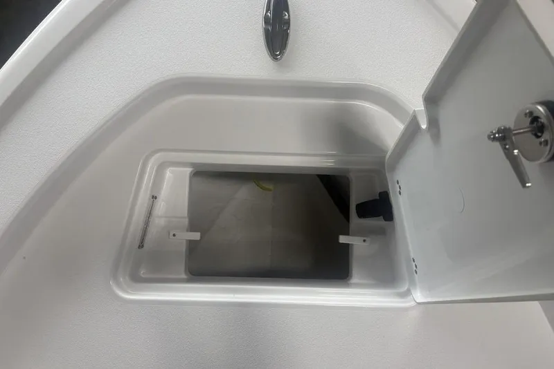 Slide: The Image of Open storage compartment on 2026 Sportsman Masters 227 boat, featuring a secure latch. - 4