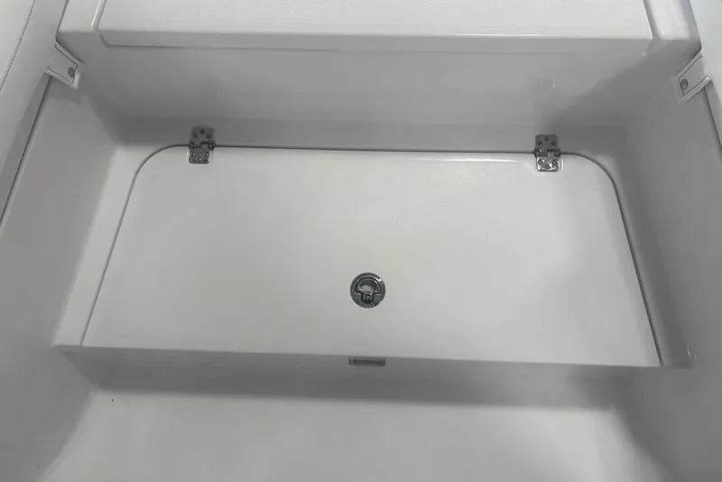 Slide: The Image of Storage compartment of 2026 Sportsman Masters 227 boat, featuring a secure latch and hinges. - 6