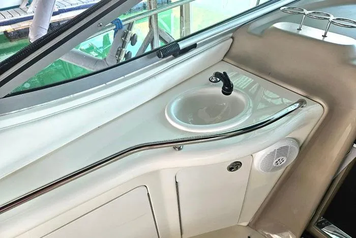 Slide: The Image of 2004 Sea Ray 300 Sundancer boat interior with sink and speaker. - 10