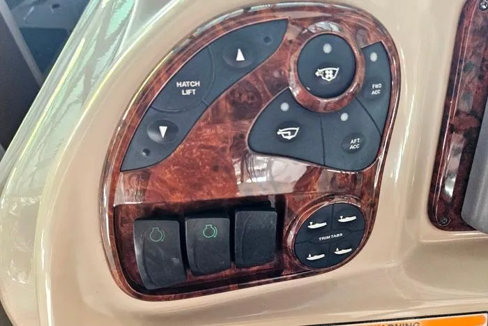 Slide: The Image of Control panel of a 2004 Sea Ray 300 Sundancer boat with various switches and buttons. - 12