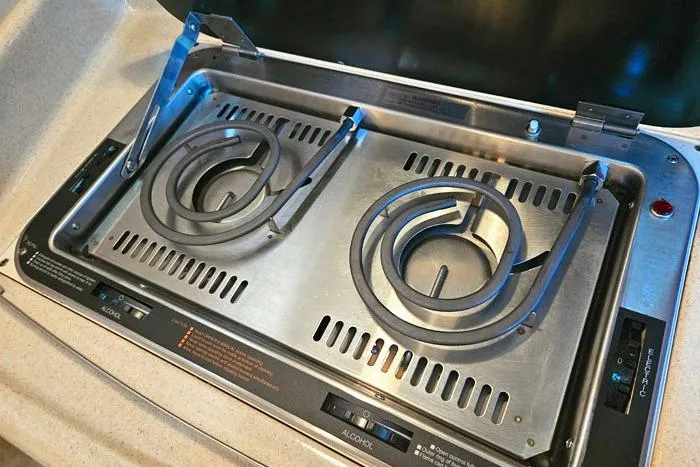 Slide: The Image of Stainless steel stove on 2004 Sea Ray 300 Sundancer boat, featuring dual electric burners. - 19