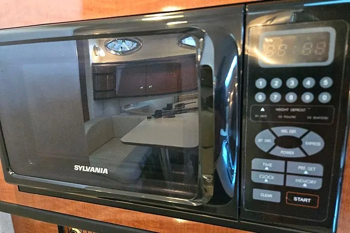 Slide: The Image of Sylvania microwave inside a 2004 Sea Ray 300 Sundancer yacht kitchen area. - 20