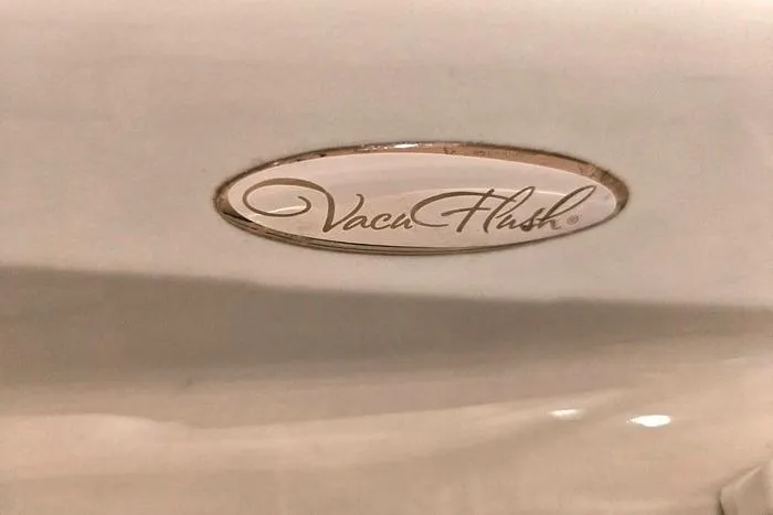 Slide: The Image of VacuFlush logo on 2004 Sea Ray 300 Sundancer boat interior. - 22