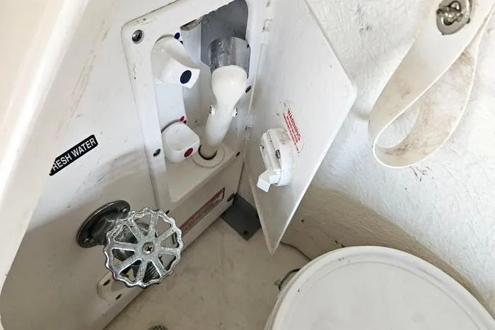 Slide: The Image of 2004 Sea Ray 300 Sundancer boat bathroom with plumbing fixtures and fresh water access. - 25