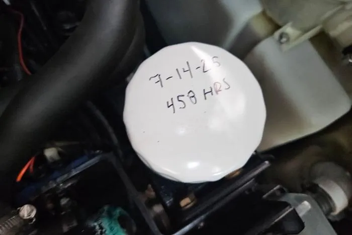 Slide: The Image of Oil filter with handwritten date and hours on a 2004 Sea Ray 300 Sundancer. - 28