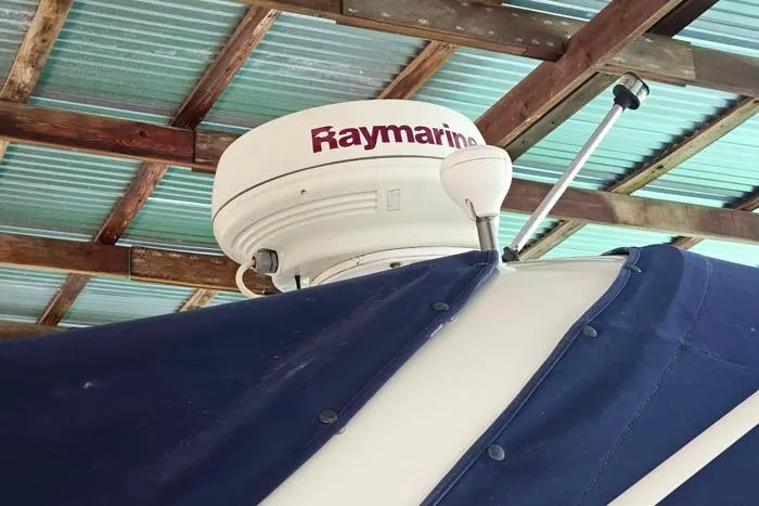 Slide: The Image of 2004 Sea Ray 300 Sundancer with Raymarine radar under a metal roof. - 7