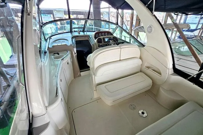 Slide: The Image of 2004 Sea Ray 300 Sundancer boat interior with helm and seating area. - 8