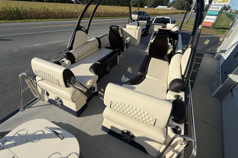 Slide: The Image of 2025 Avalon 2785 Excalibur LTD boat interior with luxurious seating and high-performance design. - 11