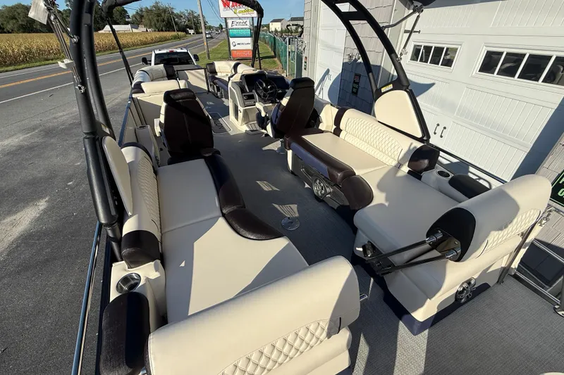 Slide: The Image of 2025 Avalon 2785 Excalibur LTD boat interior with luxurious seating and high-performance features. - 12