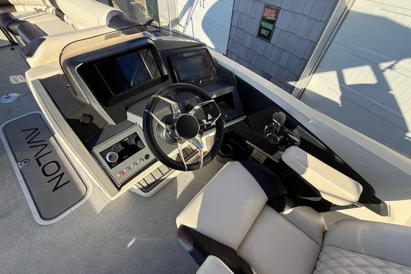 Slide: The Image of 2025 Avalon 2785 Excalibur LTD boat interior with modern steering and controls. - 26