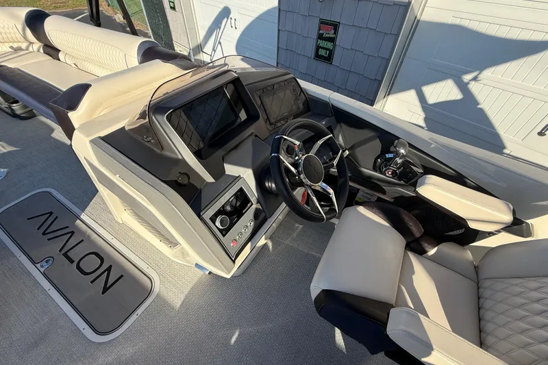 Slide: The Image of 2025 Avalon 2785 Excalibur LTD boat interior with steering wheel and seating. - 28