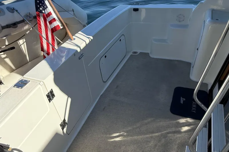 Slide: The Image of 1999 Bayliner 3788 Command Bridge Motoryacht deck with American flag and steps. - 20