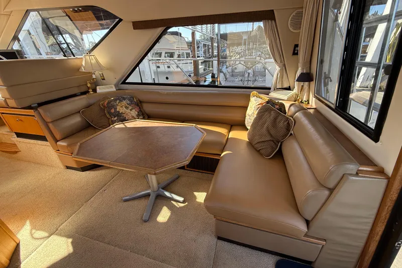Slide: The Image of Luxurious interior of 1999 Bayliner 3788 Command Bridge Motoryacht with plush seating and table. - 24