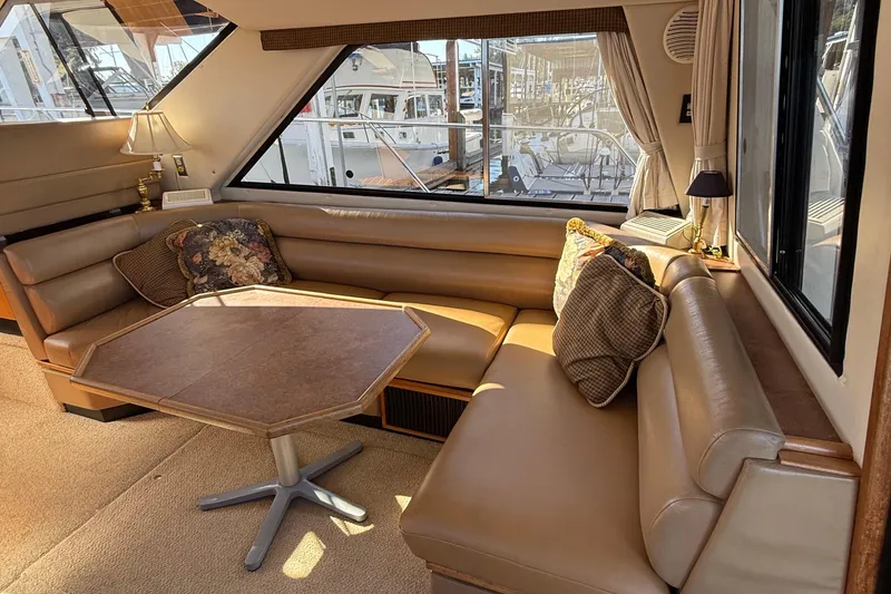 Slide: The Image of Luxurious interior of 1999 Bayliner 3788 Command Bridge Motoryacht with plush seating and table. - 25