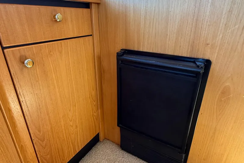 Slide: The Image of Wooden cabinetry and black appliance in 1999 Bayliner 3788 Command Bridge Motoryacht interior. - 28