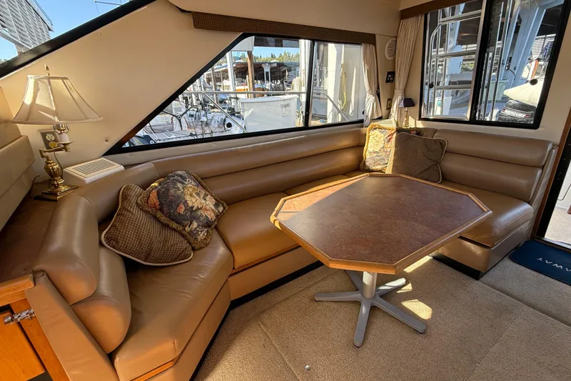 Slide: The Image of Luxurious interior of 1999 Bayliner 3788 Command Bridge Motoryacht with plush seating and table. - 29