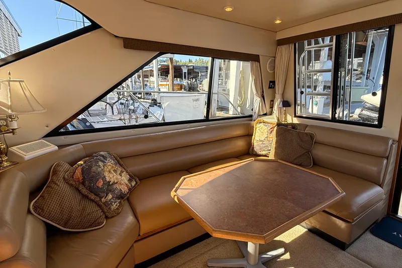 Slide: The Image of 1999 Bayliner 3788 Command Bridge Motoryacht interior with cozy seating and table. - 30
