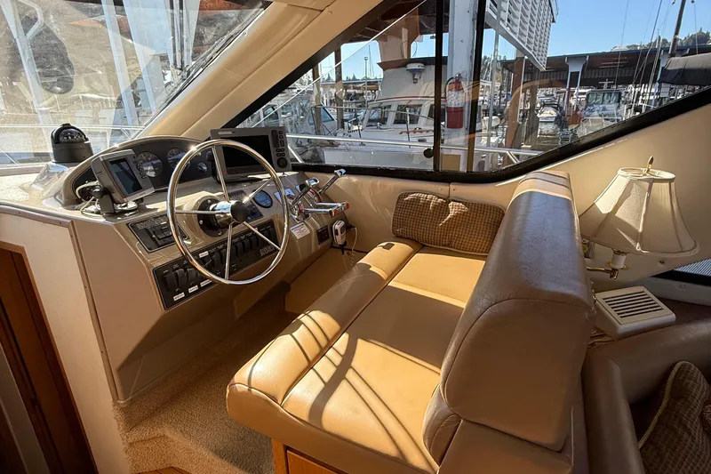 Slide: The Image of 1999 Bayliner 3788 Command Bridge Motoryacht helm with steering wheel and navigation instruments. - 31