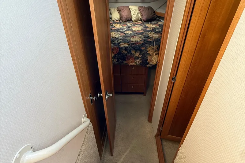 Slide: The Image of 1999 Bayliner 3788 Command Bridge Motoryacht interior with cozy bedroom and floral bedding. - 36