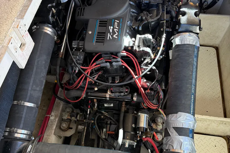 Slide: The Image of Engine compartment of a 1999 Bayliner 3788 Command Bridge Motoryacht, featuring a 7.4 MPI engine. - 46