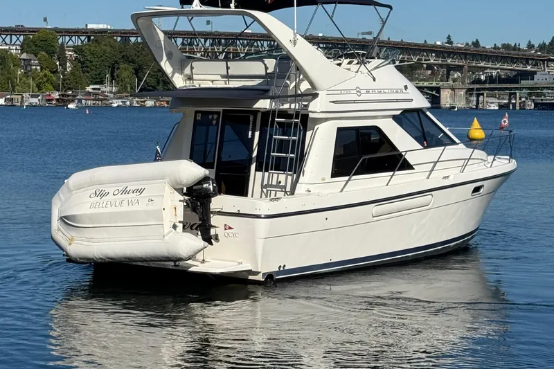 Slide: The Image of 1999 Bayliner 3788 Command Bridge Motoryacht on calm water, rear view. - 5