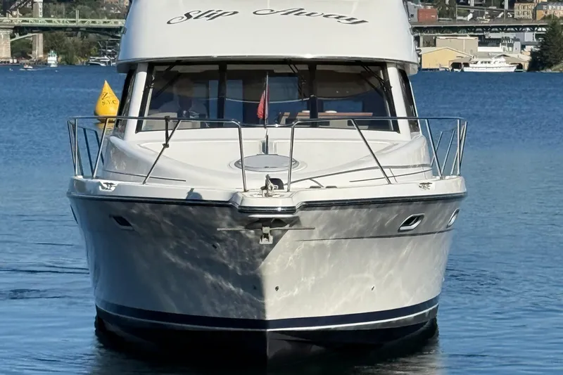 Slide: The Image of 1999 Bayliner 3788 Command Bridge Motoryacht on calm water, front view. - 9