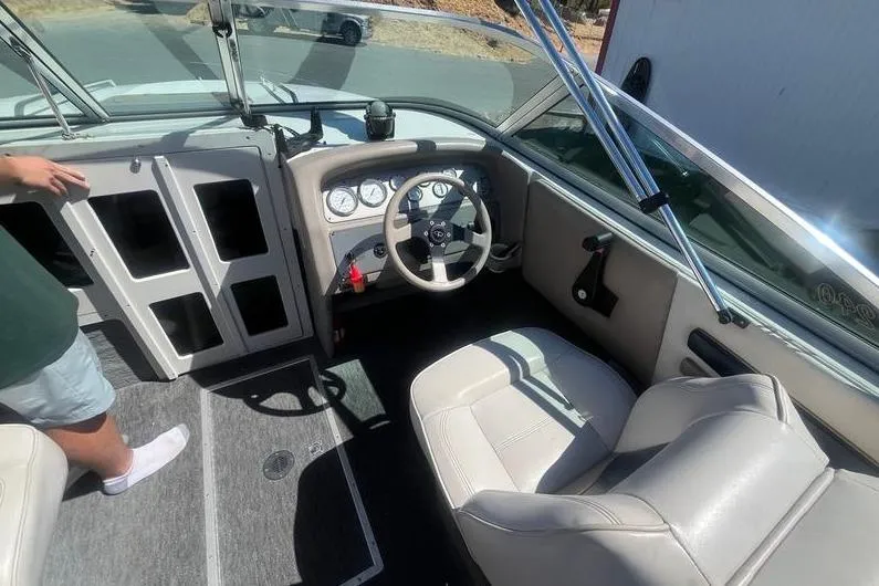 Slide: The Image of 1997 Reinell 240 boat interior with steering wheel, gauges, and seating. - 11