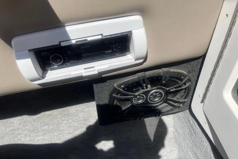 Slide: The Image of 1997 Reinell 240 boat interior with stereo system and speaker. - 14