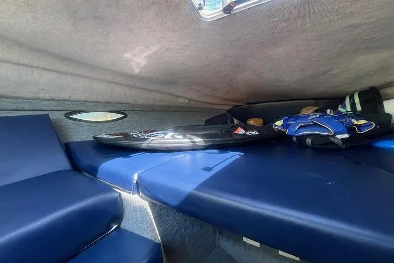 Slide: The Image of Interior cabin of a 1997 Reinell 240 boat with blue seating and gear. - 23